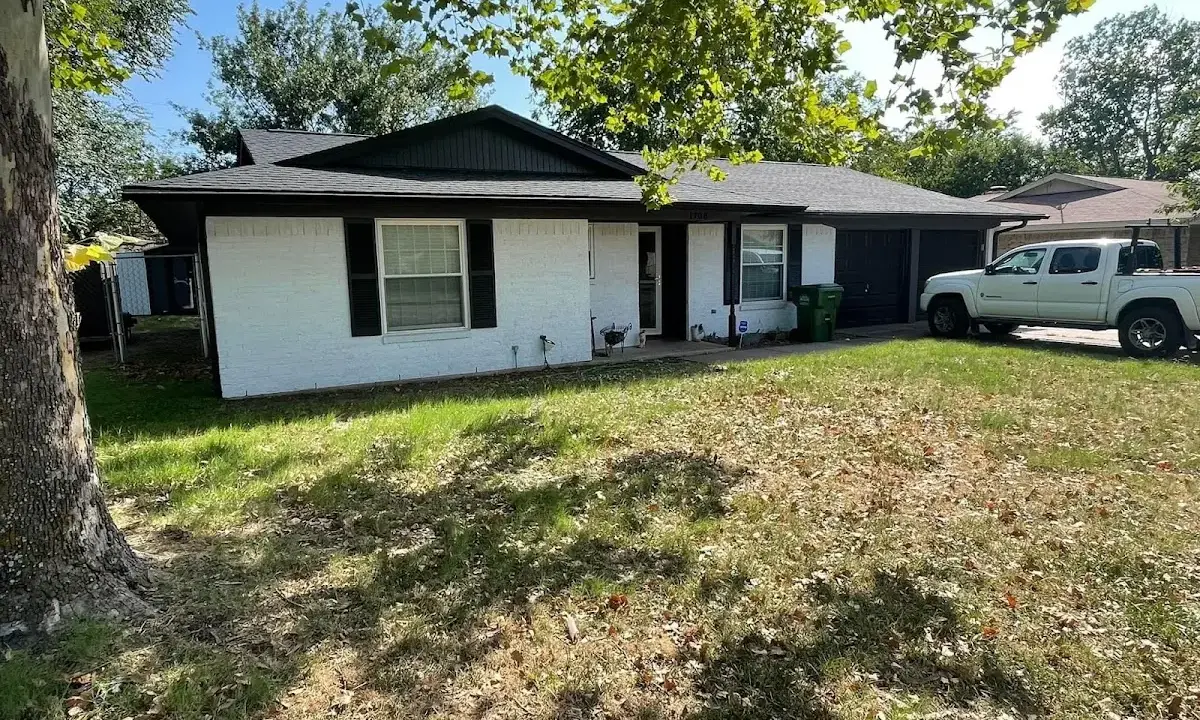 Professional roofing crew working on a residential roof in Fort Washington